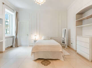 Experience elegant living in this beautifully appointed bedroom, featuring a plush single bed adorned with textured linens.