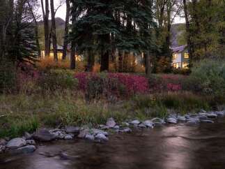 Nestled amidst a vibrant autumn landscape, this charming home offers a serene retreat.