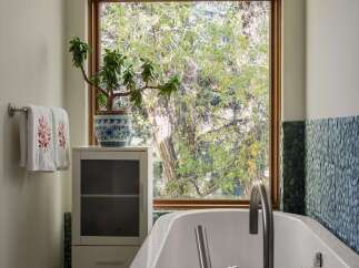 Experience tranquility in this spa-like bathroom, featuring a luxurious freestanding bathtub perfect for unwinding.