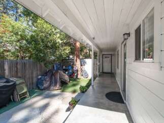 Enjoy the convenience of a covered walkway leading to your front door, providing shelter from the elements.