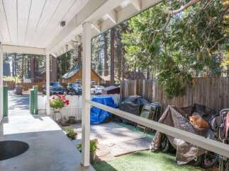 Enjoy the serene mountain setting from the covered porch of this charming property.
