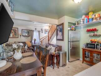 This open-concept living and dining area flows seamlessly into a functional kitchen, perfect for entertaining.
