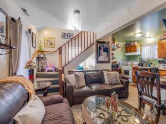Step into this inviting living space featuring plush leather sofas and a warm, neutral color palette.
