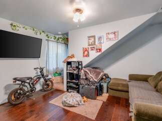 This cozy living space features a large flat-screen TV mounted on the wall, perfect for entertainment.