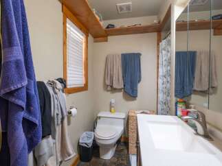 This cozy bathroom features a functional layout with a toilet and a sink.