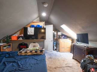 Discover this charming attic bedroom, perfect for a cozy retreat.