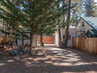 Enjoy the serene backyard of this property, complete with mature trees providing ample shade and privacy.