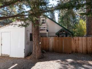 Discover this charming property featuring a detached white shed, perfect for storage or a workshop.