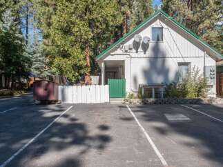 Discover this charming property nestled amongst tall pine trees, offering a serene and private setting.