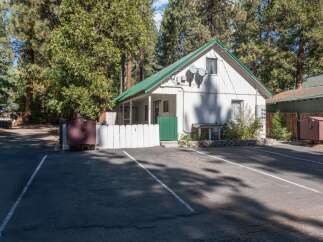 Discover this charming property nestled among tall pine trees, offering a serene and private setting.