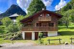 Nestled amidst lush greenery and rolling hills, this charming wooden chalet offers a serene mountain retreat.