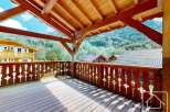 Enjoy breathtaking mountain views from this charming wooden balcony, perfect for relaxing or entertaining.
