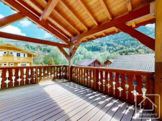 Enjoy breathtaking mountain views from this charming wooden balcony, perfect for relaxing or entertaining.