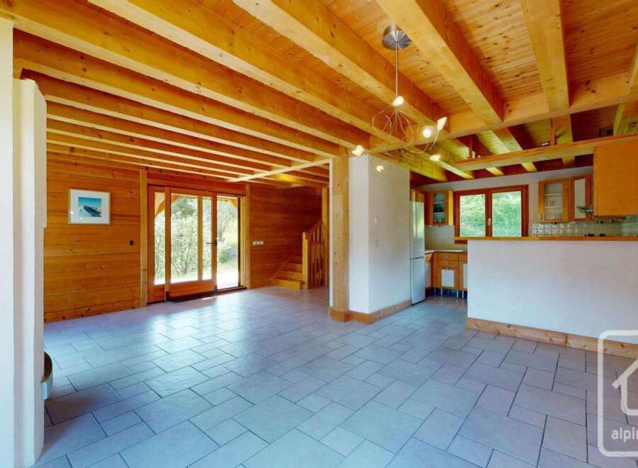 Experience the charm of this rustic wooden interior, featuring exposed beams and warm wood paneling throughout.
