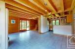Experience the charm of this rustic wooden interior, featuring exposed beams and warm wood paneling throughout.