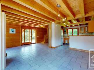 Experience the charm of this rustic wooden interior, featuring exposed beams and warm wood paneling throughout.