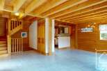 Experience the charm of this rustic wooden chalet, featuring a cozy staircase and an open-plan living area.