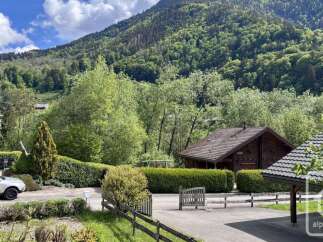 Nestled amidst lush greenery and rolling hills, this charming property offers a serene mountain retreat.