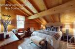 Experience the charm of this beautifully staged bedroom, featuring a cozy bed with plush, fur-trimmed pillows and a matching throw.