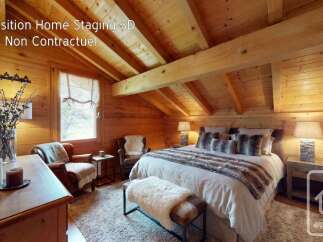 Experience the charm of this beautifully staged bedroom, featuring a cozy bed with plush, fur-trimmed pillows and a matching throw.