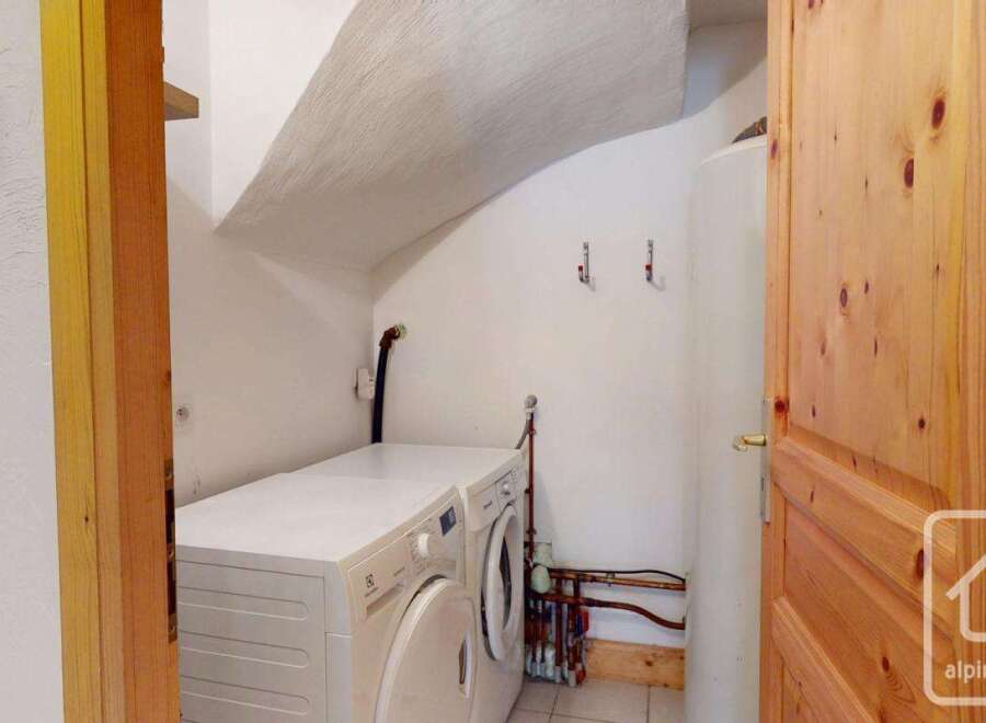 This property features a dedicated laundry area equipped with a washing machine and dryer, ensuring convenience for household chores.
