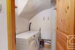 This property features a dedicated laundry area equipped with a washing machine and dryer, ensuring convenience for household chores.