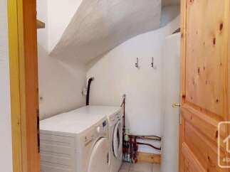 This property features a dedicated laundry area equipped with a washing machine and dryer, ensuring convenience for household chores.