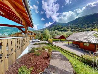 Experience the charm of alpine living in this picturesque property nestled amidst breathtaking mountain scenery.