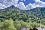 Discover this stunning property nestled amidst lush green mountains and vibrant trees, offering breathtaking natural views.