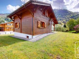 Nestled in a serene mountain landscape, this charming wooden chalet offers a picturesque retreat.