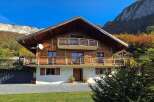Experience the charm of this stunning wooden chalet nestled amidst breathtaking mountain scenery.