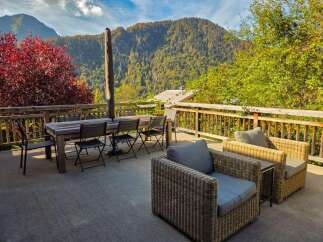 Enjoy breathtaking mountain views from this spacious outdoor patio, perfect for al fresco dining or relaxing with a book.