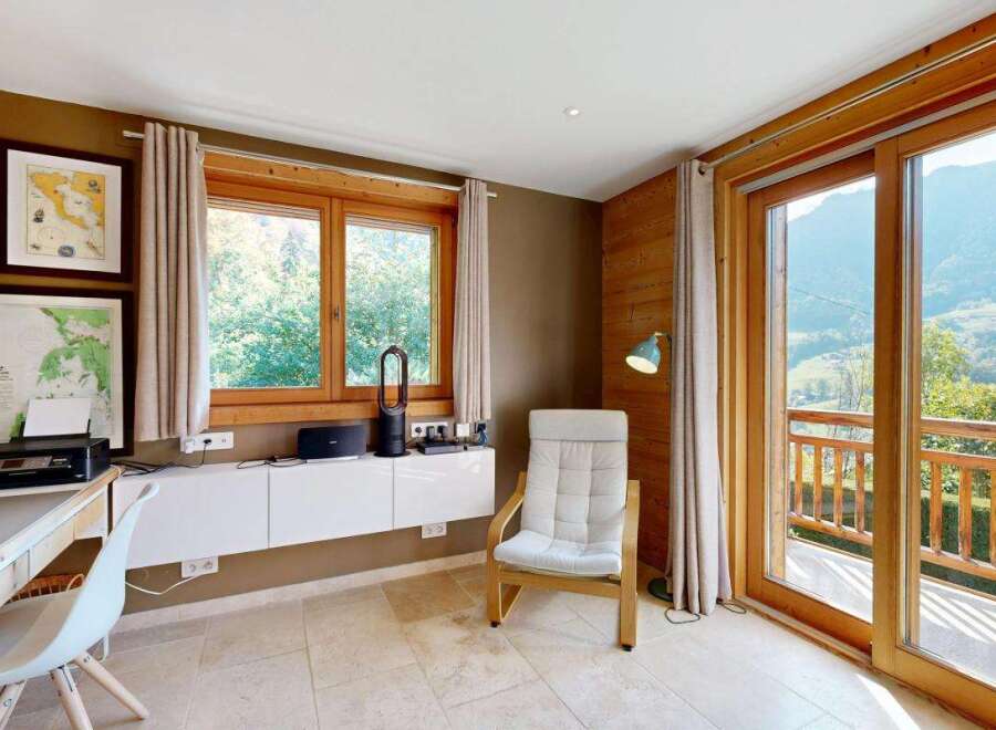 This charming room offers a dedicated workspace with a desk, printer, and shelving, perfect for remote work or study.