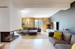 Experience modern living in this spacious living room, featuring a sleek gas fireplace and a large sectional sofa perfect for relaxation.