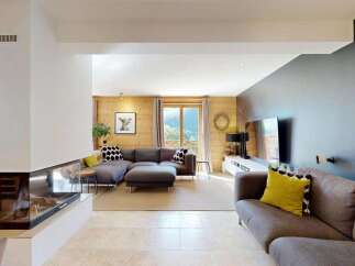 Experience modern living in this spacious living room, featuring a sleek gas fireplace and a large sectional sofa perfect for relaxation.