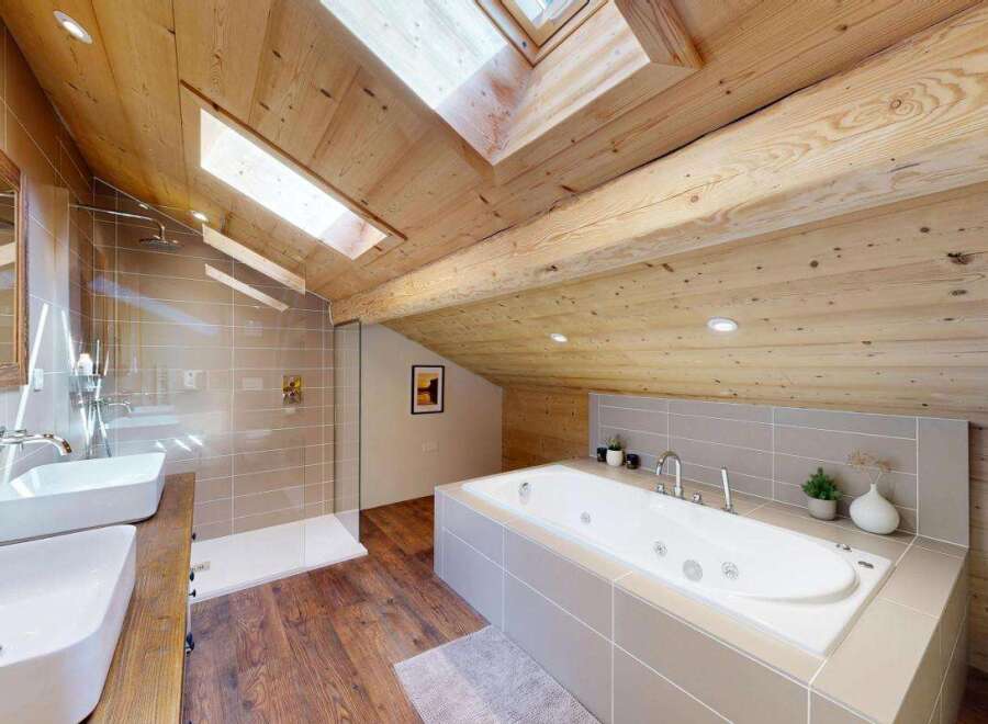 Experience luxury in this stunning attic bathroom, featuring a spacious soaking tub and a separate walk-in shower.