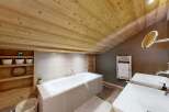 Experience rustic luxury in this stunning bathroom, featuring a spacious bathtub and dual sinks.
