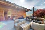 Enjoy stunning mountain views from this spacious wooden chalet's outdoor patio, perfect for al fresco dining or relaxing.