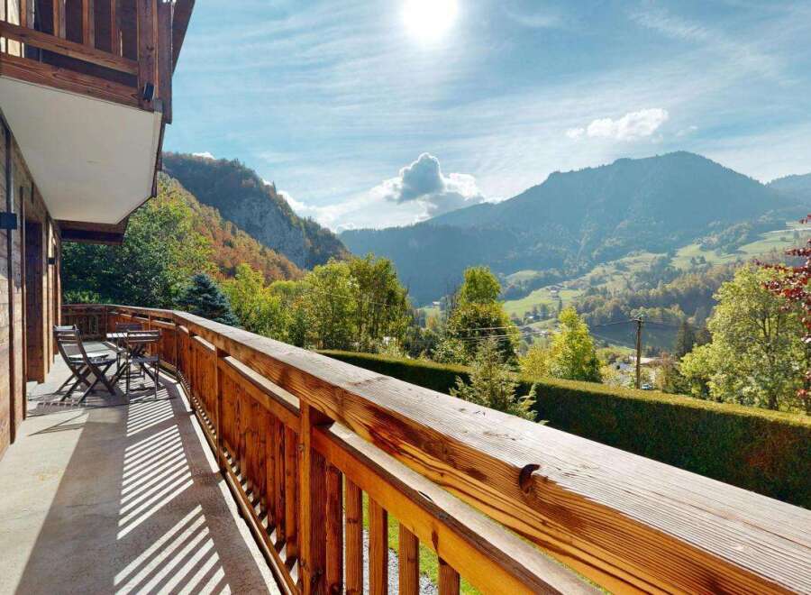 Enjoy breathtaking mountain views from the private balcony of this charming wooden chalet.