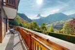 Enjoy breathtaking mountain views from the private balcony of this charming wooden chalet.