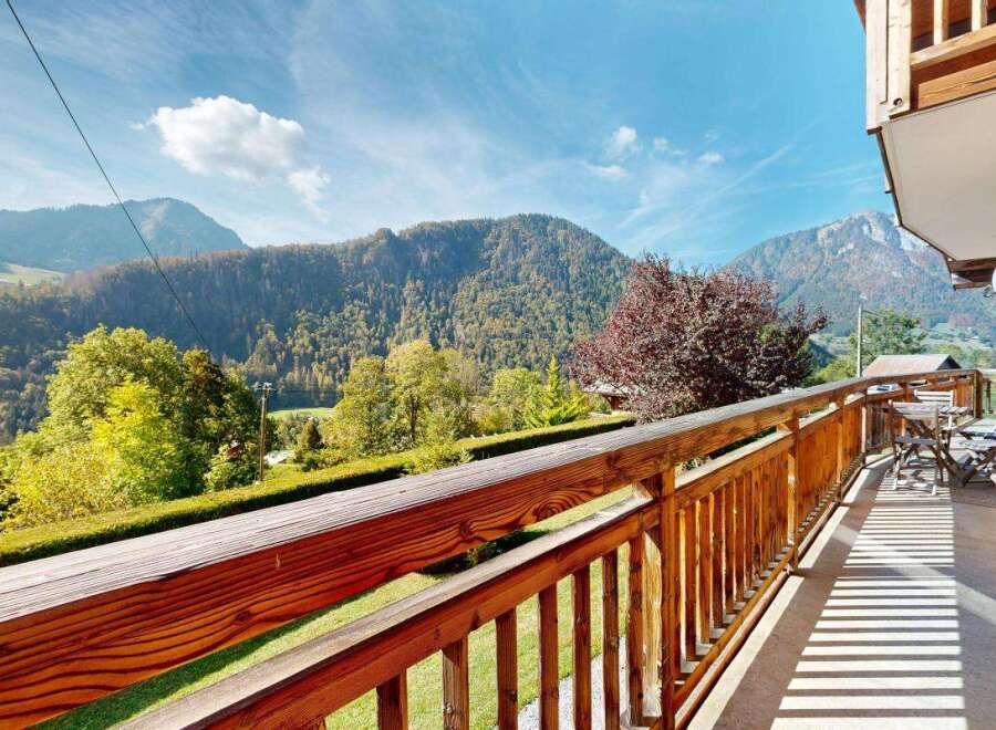 Enjoy breathtaking mountain views from this charming wooden balcony, perfect for your morning coffee or evening relaxation.