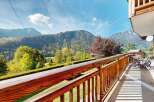 Enjoy breathtaking mountain views from this charming wooden balcony, perfect for your morning coffee or evening relaxation.
