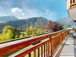 Enjoy breathtaking mountain views from this charming wooden balcony, perfect for your morning coffee or evening relaxation.