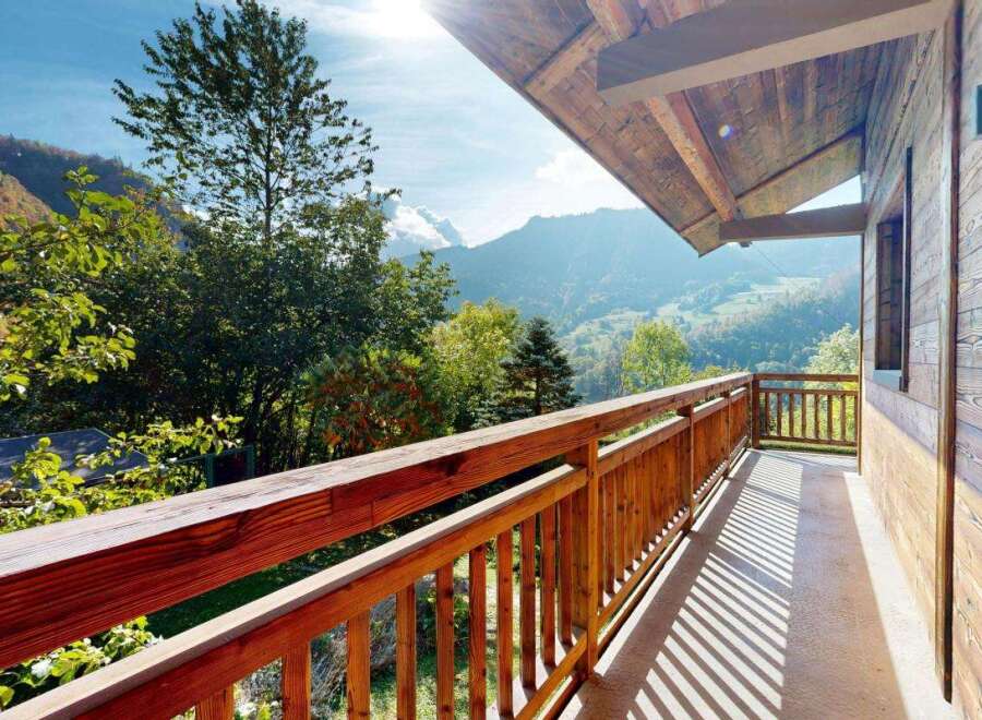 Enjoy breathtaking mountain views from this charming wooden balcony, perfect for your morning coffee or evening relaxation.