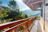 Enjoy breathtaking mountain views from this charming wooden balcony, perfect for your morning coffee or evening relaxation.
