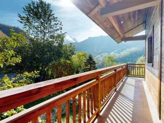 Enjoy breathtaking mountain views from this charming wooden balcony, perfect for your morning coffee or evening relaxation.