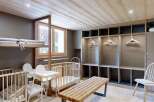 This charming nursery room features two wooden cribs, each equipped with a comfortable mattress and a pillow.