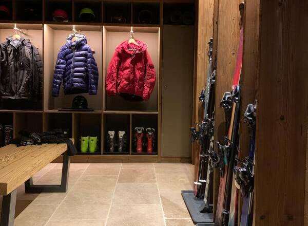 Experience the ultimate ski lodge ambiance with this meticulously organized ski room.