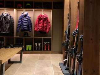 Experience the ultimate ski lodge ambiance with this meticulously organized ski room.