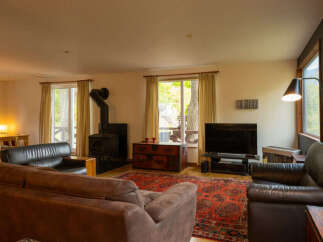 This spacious living room offers a cozy and inviting atmosphere, perfect for relaxation and entertainment.